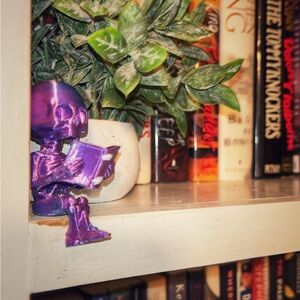 Metallic Purple Reading Skeleton Shelf Decor